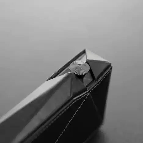 Dignis case for AK SP3000M Close-up of a black geometric object with a reflective surface on a gray background