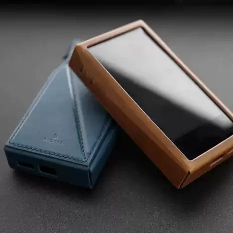 Dignis case for AK SP3000M Two phone cases, one blue and one brown, on a dark surface.